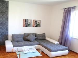 a living room with a couch and a table at Apartment Dvorska in Crikvenica