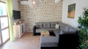a living room with a couch and a table at Villa Anna - 4 bedrooms, 4 bathrooms, heated pool, jacuzzi in Kornić