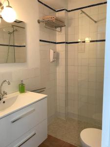 a bathroom with a sink and a shower at Casa Azul in Bolonia +22 photos