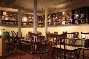 a restaurant with a table and chairs in a room at Kawaguchiko Hotel in Fujikawaguchiko
