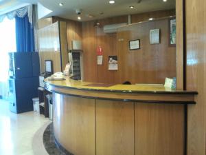 a lobby with a large wooden bar in a hospital at Hotel Ciudad de Fuenlabrada in Fuenlabrada