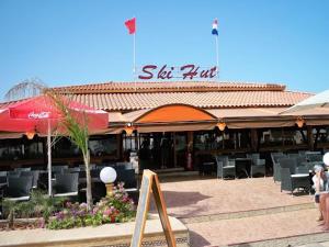 a building with a restaurant with tables and chairs at Appart Clim Wifi 700m de la Plage in Saïdia