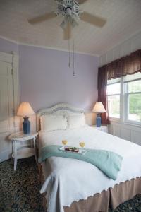 a bedroom with a bed with two glasses on it at Market Street Inn in Taylorville