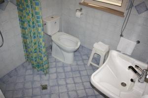 a white toilet sitting next to a bath tub in a bathroom at Di Matteo Hotel in Roseto degli Abruzzi