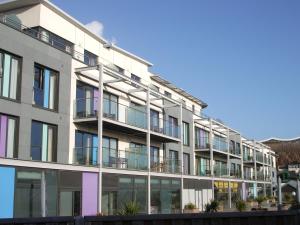an apartment building with a lot of windows at Liberty Wharf Apartments in Saint Helier Jersey