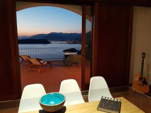 a bowl on a table with a view of a balcony at Villa Crawford in San Nicola Arcella