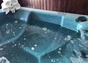 a jacuzzi tub with a faucet and some towels at FairBridge Inn and Suites Sandpoint in Ponderay +24 photos