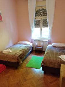 um quarto com 2 camas e uma janela em Rooms Portorose Center em Portorož