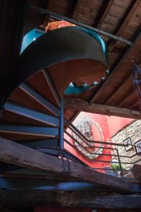 a spiral staircase in a building with a painting on the wall at Hotel Rural Casa de Las Campanas in Salinas de Pisuerga