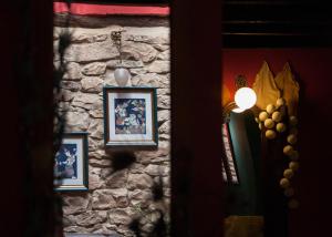 un muro di pietra con immagini e una luce sopra di Hotel Rural Casa de Las Campanas a Salinas de Pisuerga