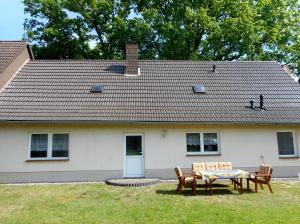 a house with a table and chairs in front of it at Ferienwohnung Hille in Arendsee