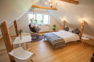 a bedroom with a bed and a table and chairs at Ligatne Homestay in Līgatne