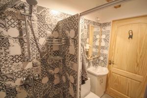 a bathroom with a shower and a toilet and a sink at Ligatne Homestay in Līgatne