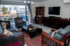 a living room with a couch and a tv at 3 Spinnaker The Quays in Knysna