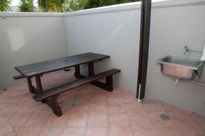 a wooden bench next to a sink in a bathroom at 3 Spinnaker The Quays in Knysna +34 photos