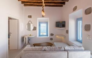 a living room with a couch and a table at Plaka Suites in Plaka Milou