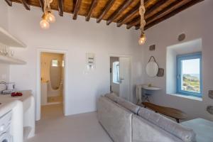 a living room with a couch and a window at Plaka Suites in Plaka Milou