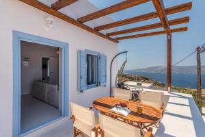 a wooden table on the balcony of a house at Plaka Suites in Plaka Milou