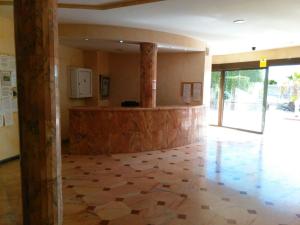 a lobby with a stone floor and a pillar at COLINA BLANCA TENERIFE. in Adeje