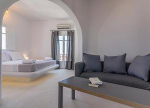 a living room with a couch and a table at Plaka Suites in Plaka Milou
