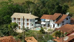 an aerial view of a house with a pool at Pousada Pedacinho do Céu in Conservatória