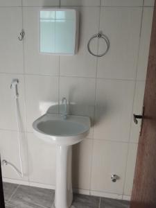 a bathroom with a white sink and a mirror at Pousada Centaurus in Alto Paraíso de Goiás