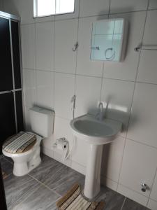 a bathroom with a sink and a toilet at Pousada Centaurus in Alto Paraíso de Goiás +37 photos