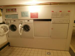 a laundry room with two washer and dryer at Namur Energîte in Namur