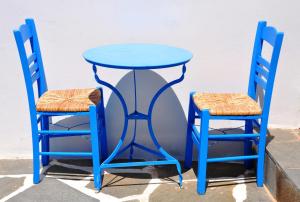 a blue table and two chairs sitting next to at Margarita Hotel in Kythira +37 photos