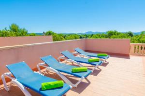 a row of blue lounge chairs on a roof at Finca Rustica Arcos in Campos