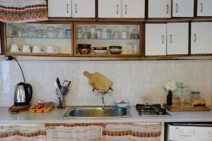 a kitchen with a sink and a counter top at Hikers Hostel in Veliko Tŭrnovo