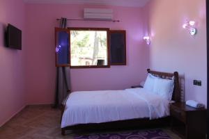 A bed or beds in a room at Hôtel Ajil Cascades D'ouzoud