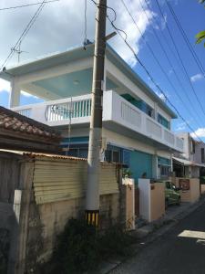 a house with a pole in front of it at Dolphins and Whales in Ishigaki Island