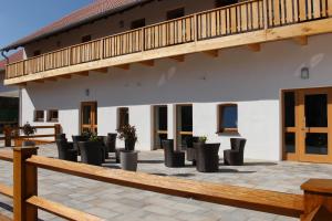 a row of chairs on a patio in front of a building at SPIEGLHOF apart in Kumhausen +7 photos