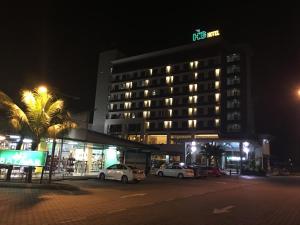 a hotel with cars parked in a parking lot at night at HIG Hotel in Kuah