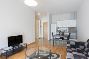 a living room with a couch and a table at ForRest Apartments in Vilnius