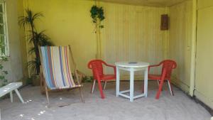 two chairs and a table and a table and chairs at Summer bungalo trailer in Jūrmala