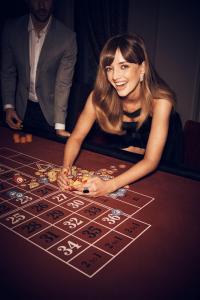 a woman playing a game on a poker table at Treasury Brisbane in Brisbane