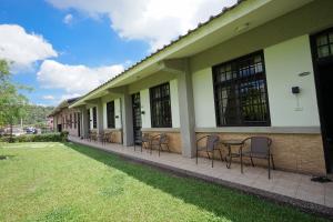 a group of chairs sitting outside of a building at Tobacco Village in Meinong