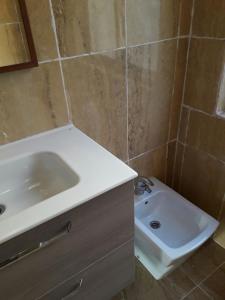 a bathroom with a white sink and a toilet at Apartamento Sofia in Valencia
