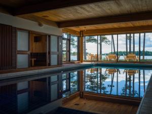 a house with a swimming pool with a view of the water at Hotel Hanasaari in Espoo