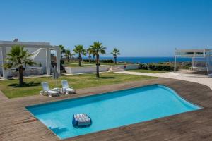 a swimming pool with a remote control on top of it at Reveli Estate in Kalathas