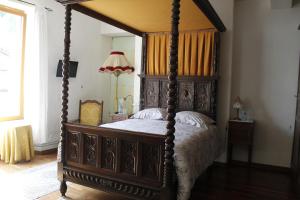 a bedroom with a four poster bed with a canopy at Le Val du Roy in Joinville