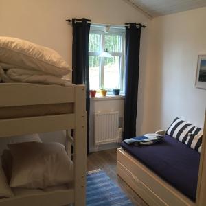 a bedroom with two bunk beds and a window at Stuga i Ullared in Ullared