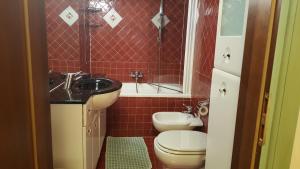 a bathroom with a sink and a toilet and a tub at Residence La Repubblica in Florence