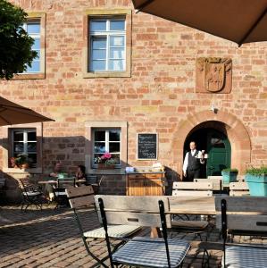 a man standing in the doorway of a brick building at Kloster Hornbach in Hornbach