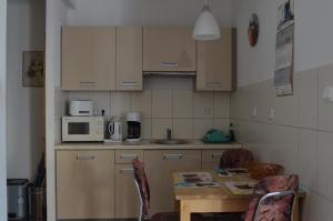 a small kitchen with a table and a microwave at Apartament Irek 1000L PP in Międzyzdroje