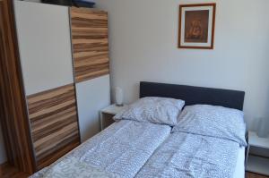 a bedroom with a bed and a wooden door at Apartament Irek 1000L PP in Międzyzdroje