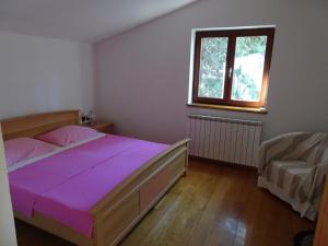 1 dormitorio con cama, ventana y sofá en Apartments Premantura en Premantura
