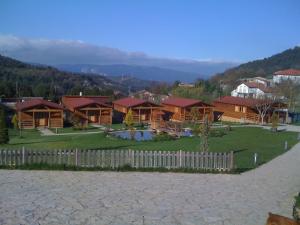 a group of houses with a fence in a field at La Cabaña Rural in Paúl